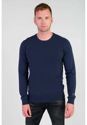Pull en tricot bleu marine à manches longues et col rond. Doté de poignets côtelés et d'un petit logo sur la manche.