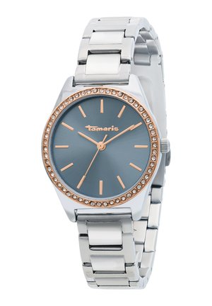 Silberne Metallarmbanduhr mit blauem Zifferblatt, roségoldenen Stundenmarkierungen und Zeigern, einer kristallbesetzten Lünette und dem "Tamaris"-Logo auf dem Zifferblatt.