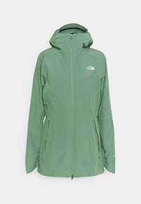 Hellgrüne wasserdichte Jacke mit Kapuze, Reißverschluss vorne und zwei Seitentaschen. Hat ein Logo auf der linken Brust und elastische Bündchen.