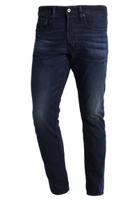 Tmavě modré skinny džíny vyrobené z denimového materiálu, se designem pěti kapes, poutek na opasek a jemnými detaily v oblasti stehen.