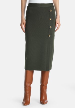 Knit pencil skirt in dark green with a high waist, side button closure featuring four gold-tone buttons, paired with brown knee-high boots.
