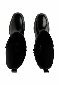 Pair of black shiny leather ankle boots with rounded toes viewed from above, showing tops and insides.