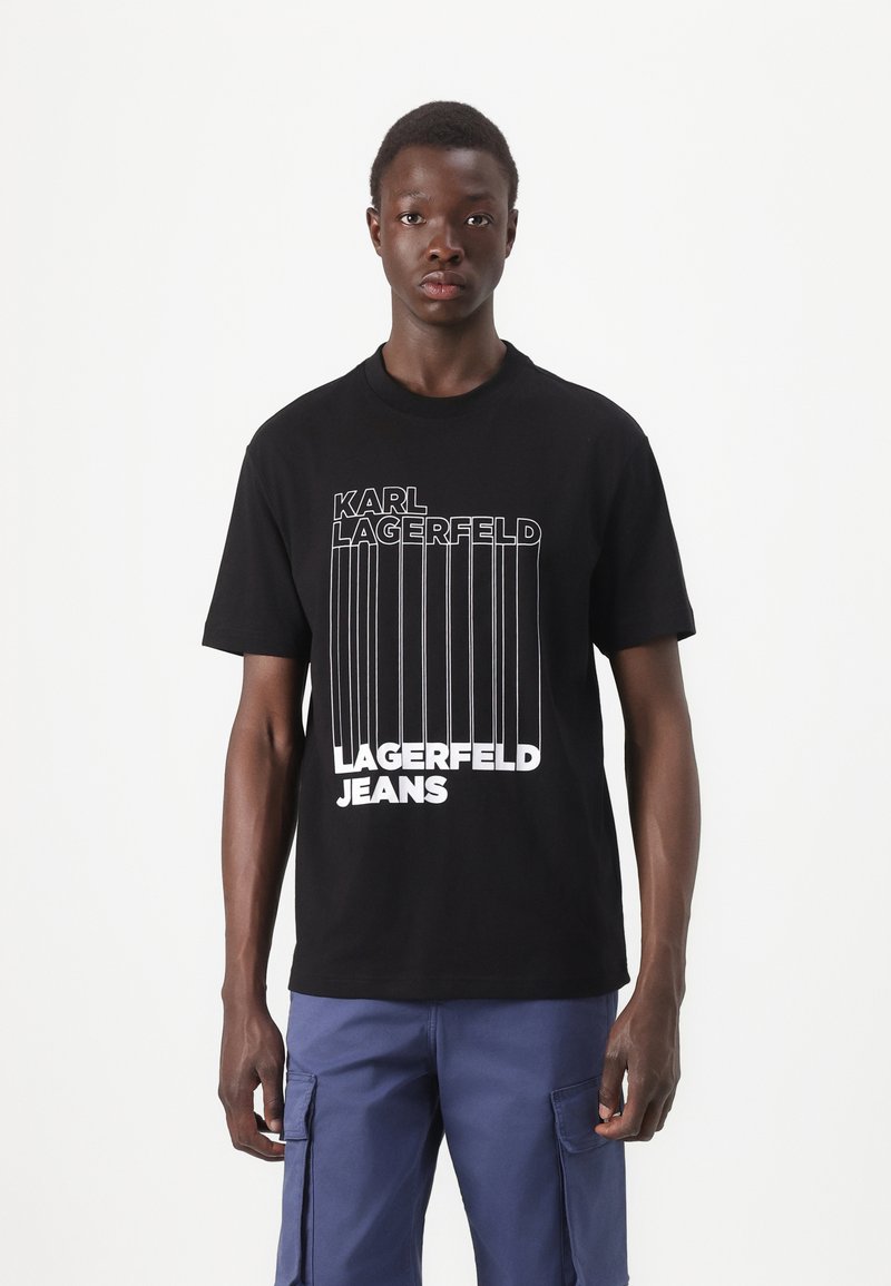 Svart bomullst-skjorte med "KARL LAGERFELD" og "JEANS" i fet hvit tekst. Korte ermer og klassisk rund hals.