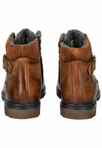 Bruine leren enkelboots met een zachte grijze voering, twee zijritsen en een gestructureerde bruine bovenkant met een rubberen zool voor grip.
