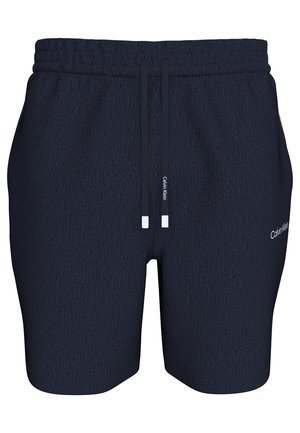 Σκούρο μπλε ανδρικό σορτς Calvin Klein με ελαστική μέση, ρυθμιζόμενα κορδόνια και λογότυπο στην εξωτερική πλευρά του δεξιού ποδιού.