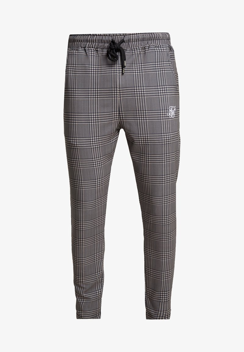 Zwart-wit geblokte sweatpants met een elastische tailleband, verstelbare trekkoord en subtiele logo-details op de dij.
