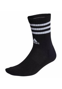 Calcetín atlético negro hecho de tela de punto con un borde acanalado en la parte superior. Presenta tres franjas blancas horizontales y un logotipo de Adidas cerca del tobillo.