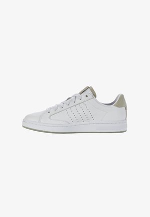 Zapatilla de cuero blanca con acentos en gris claro, punta redonda, suela plana de goma, detalle lateral perforado y panel trasero texturizado en contraste.