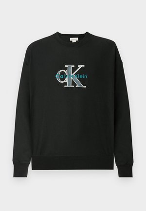 Sweatshirt preta feita de algodão, com gola redonda, mangas compridas e um logótipo gráfico "CK" em branco e verde água no peito.