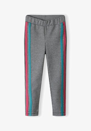 Zwart-witte houndstooth enkellange leggings met een elastische tailleband en contrasterende roze en blauwe zijkanten.
