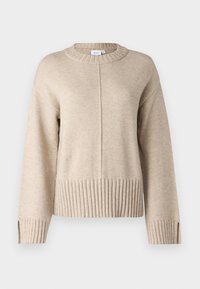 Beige stickad tröja med ribbad nederkant och ärmar, med rund halsringning och en något avslappnad passform. Ren, strukturerad tyg.