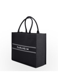 Black tote bag made of fabric, featuring a structured rectangular design, dual handles, and a white logo with stripes on the front.