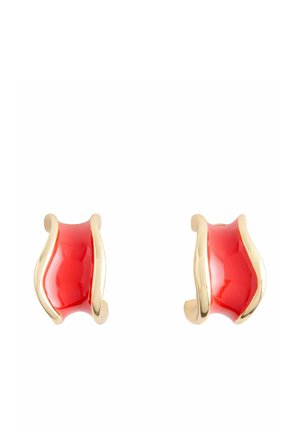 Pair of small curved earrings with red enamel centers and gold-tone edges on a white background.