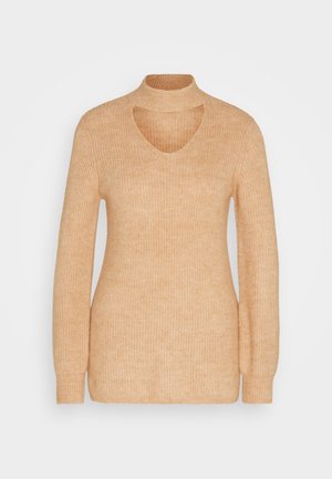Lys beige ribbestrikket genser med høy hals, åpen brystdetalj og lange ermer. Myk tekstur og tettsittende design.