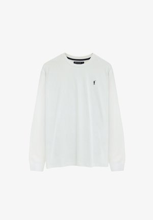 Camiseta blanca de manga larga con cuello redondo y pequeño logo de jugador de polo negro en el pecho izquierdo, con la etiqueta "Polo Club" en el interior del cuello.