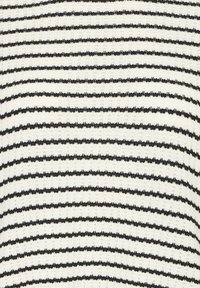 Tissu blanc tricoté avec des fines rayures horizontales noires uniformément espacées, montrant en gros plan la texture et le motif.