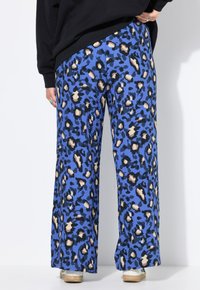 Pantalon large bleu avec un motif léopard noir et beige. Fabriqué en tissu texturé, il présente une coupe décontractée et droite.