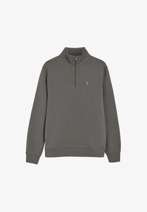 Sweatshirt gris à col montant avec fermeture éclair quart, fabriqué en tissu doux, avec des manches longues et un petit logo sur la poitrine.