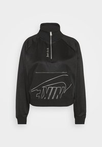 Svart kortad sweatshirt med hög krage, halvdragkedja framtill och framficka. Har stor vit "NIKE"-tryck och texten "Just do it".