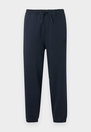 Pantalon de jogging bleu marine avec ceinture élastique, cordon de serrage ajustable, jambes fuselées et ourlets retroussés.