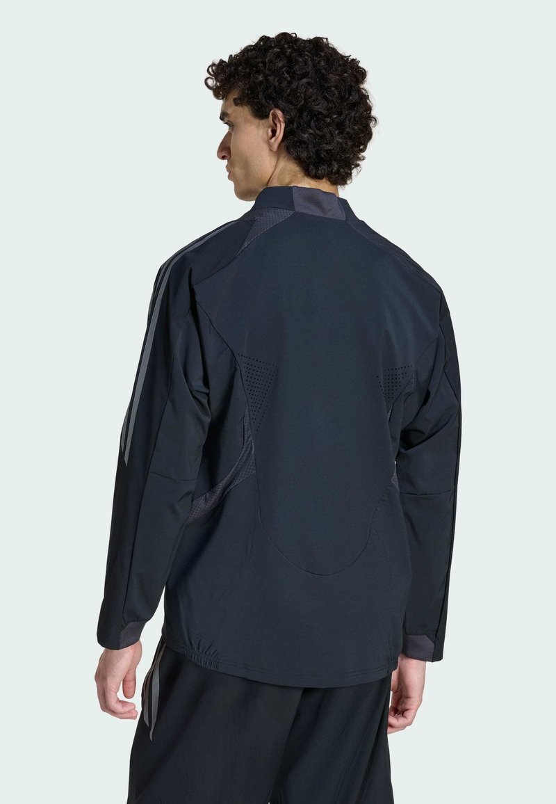 Black, lightweight jacket with a high collar, layered design, and mesh accents. Features long sleeves and a relaxed fit for ease of movement.