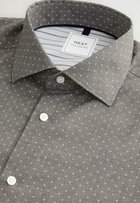 Gray button-up shirt featuring subtle white diamond patterns, a classic collar, and a striped inner lining. Buttons are round and white.