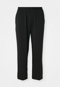 Pantalon noir Calvin Klein avec une taille élastique, coupe droite, texture lisse, sans poches visibles ni motifs.