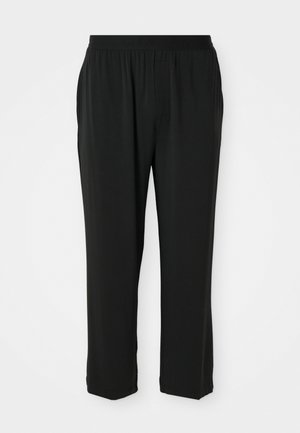 Schwarze Calvin Klein-Hosen mit einem elastischen Bund, geradem Bein, glatter Textur und ohne sichtbare Taschen oder Muster.
