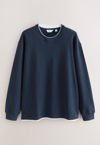 Navy sweatshirt with long sleeves, ribbed texture, and a round neckline. Features a white accent at the hem and collar for contrast.