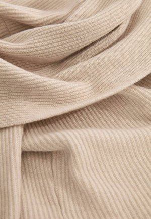Weiches, beiges, geripptes Material in fließender Anordnung, das ein strukturiertes Design mit horizontalen Linien und einer glatten Oberfläche zeigt.