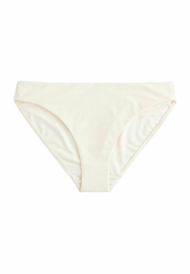 Krém színű bikini alsó sima, rugalmas anyagból készült. Közepes magasítással rendelkezik, keskeny oldalvarrásokkal és varrat nélküli kialakítással.