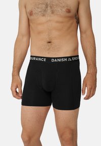 Svarta bomullsboxershorts med en figurnära design, en märkesemblemelastisk midjeband och en framficka. Mjuk textur och skräddarsydd form.