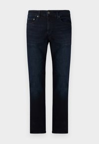 Mörk tvättade jeans i rak modell, med framfickor och knäppning, allt i en slät textur.