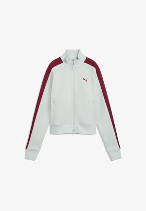 Biała kurtka zapinana na suwak z wysokim kołnierzem, bordowe paski na rękawach, kieszenie na suwak oraz małe bordowe logo Puma na lewej piersi.