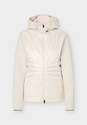 Cream-colored women's jacket with a hood, front zipper, quilted padded front, and smooth fabric sleeves.