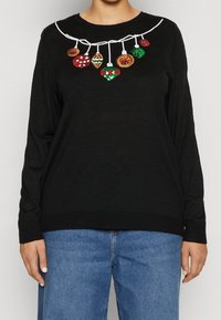 Black sweater with long sleeves and a round neckline. Features a white embroidered string with colorful ornament designs.