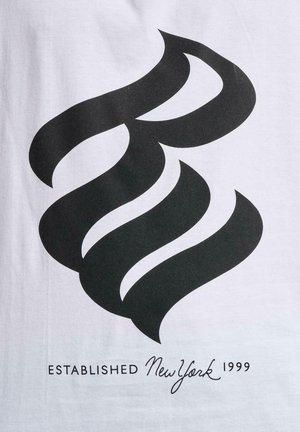 White t-shirt featuring a large black graphic resembling stylized flames. Text below reads "ESTABLISHED New York 1999" in black font.