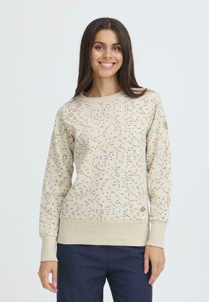 Ljusbeige sweatshirt med färgglada prickmönster, ribbade ärmslut och nederkant, samt dekorativa knappar på axeln. Mjuk tygtextur.