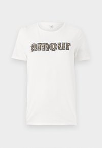 White cotton t-shirt featuring "amour" text in a leopard print design. Short sleeves and a round neckline. Lightweight and casual fit.