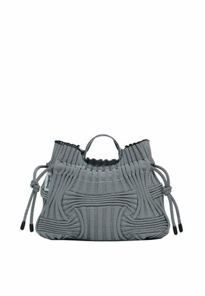 Black and white striped fabric bag with a gathered top, adjustable drawstring closures, and a textured surface. Compact, structured shape.