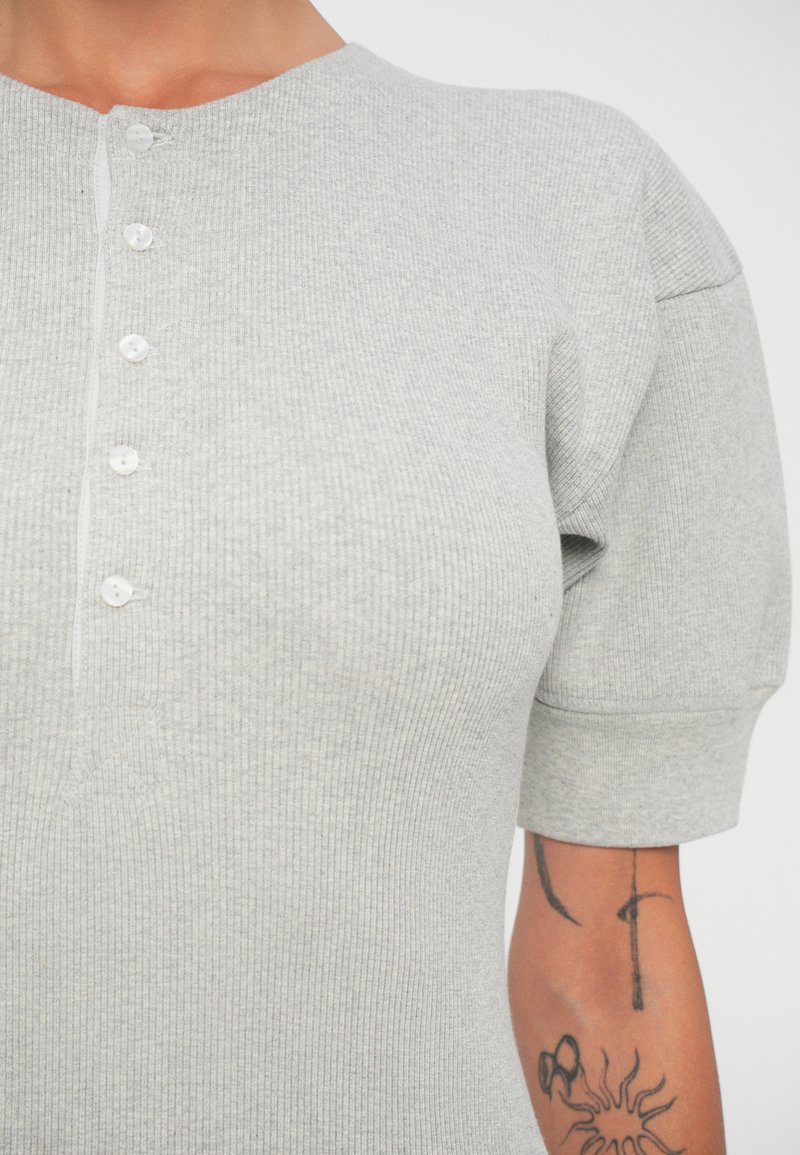 Heather gray ribbed short-sleeve top with a round neckline, five-button placket, and subtle vertical texture.