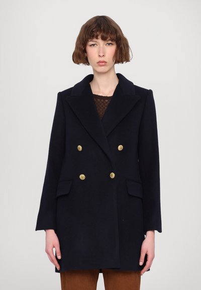 Navy double-breasted coat in wool blend with gold buttons, peaked lapels, and side pockets; tailored fit with a smooth texture.