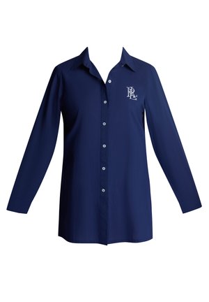 Μακρυμάνικο πουκάμισο σε ναυτικό μπλε χρώμα με μυτερό γιακά, κουμπιά στο μπροστινό μέρος και λογότυπο στην αριστερή πλευρά του στήθους. Υφασμάτινη υφή λεία.