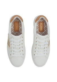 White sneakers with a smooth leather finish, featuring gold-tone eyelets, a tan heel accent, and a geometric patterned insole.