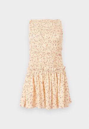 Rihmadeta kreemikas kleit, millel on voltidega ülaosa ja volangidega seelik, kaetud väikeste punaste täpikestega.