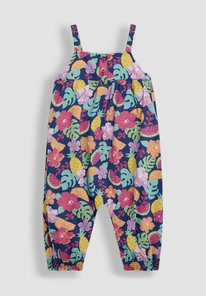 Ziedu raksta kombinezons ar zilu fonu, elastīgiem aprocēm, regulējamām siksnām un krāsainiem tropiskajiem motīviem, tostarp augļiem un ziediem.