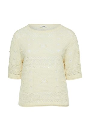 Top en maille crème à manches courtes avec des motifs complexes en forme de dentelle et un col rond.