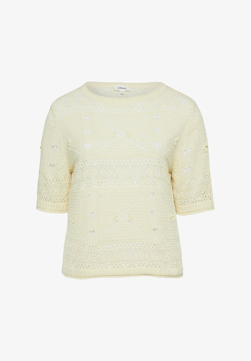 Top en maille crème à manches courtes avec des motifs complexes en forme de dentelle et un col rond.
