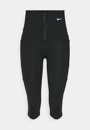Black capri leggings made of stretchy fabric, featuring a front zip and side pockets, with a small white logo on the waistband.