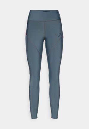 Tume sinine kõrge talje leggins, millel on sile tekstuur. Omab nurksemeid, väikest logo ja roosa aksendiga lukuga taskut.